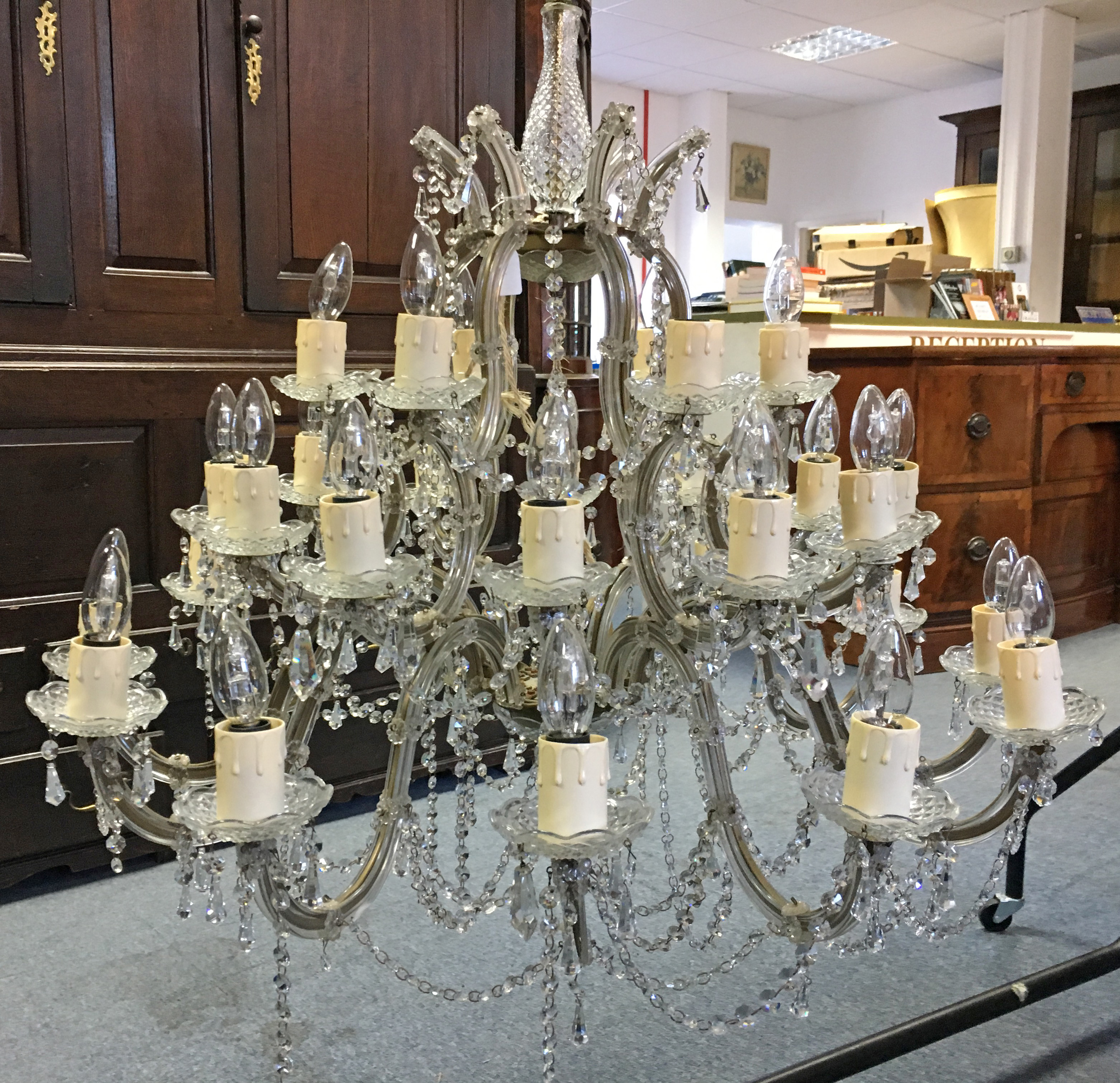 A CUT-GLASS THIRTY-BRANCH CHANDELIER of foliate scroll design, all-over hung with beads & prism