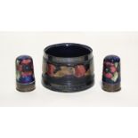 A Moorcroft “Pomegranate” round tapered pot with pewter rim, painted initials & impressed marks,