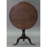 An 18th century oak tripod table with circular tilt-top on vase-turned centre column & cabriole legs