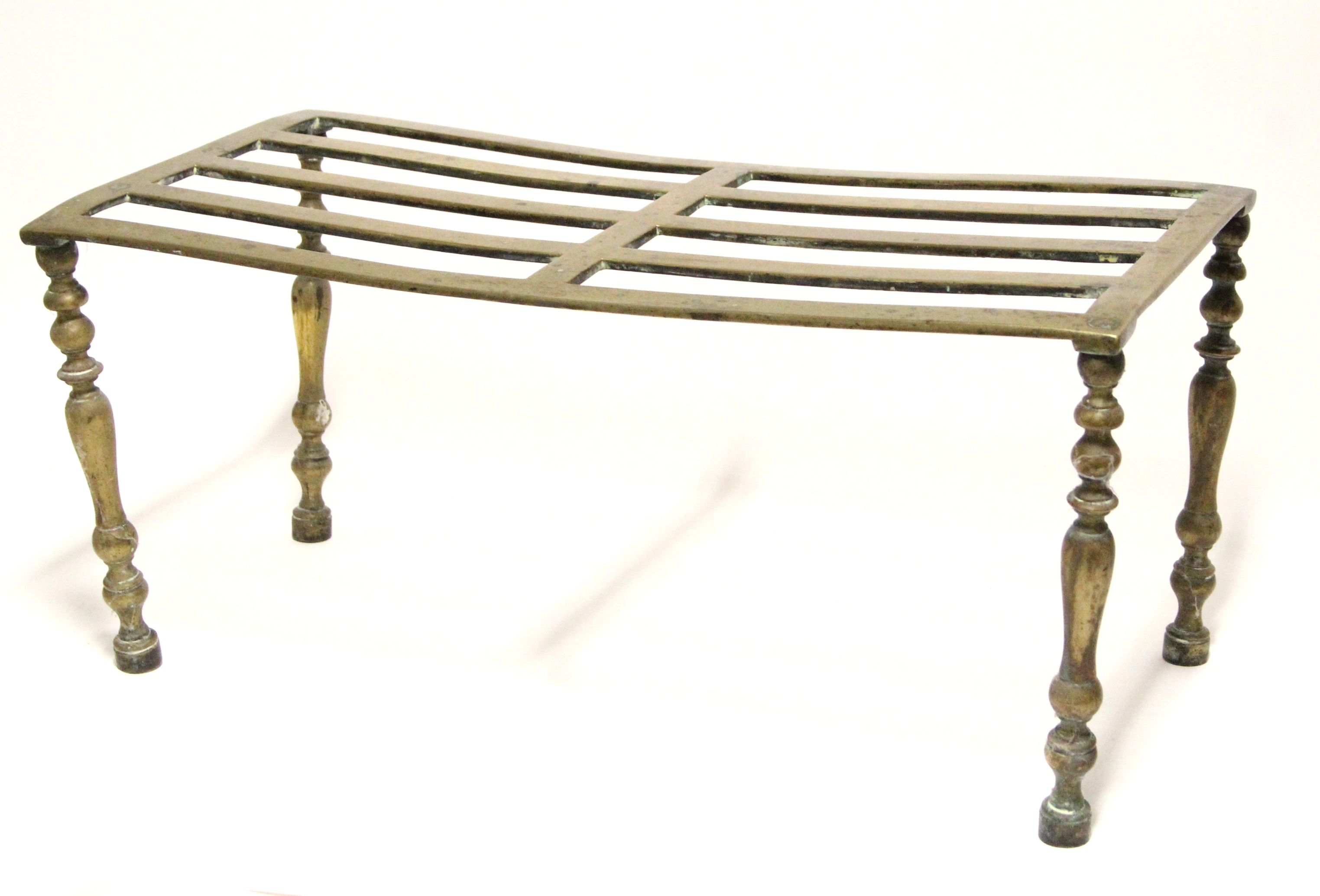 An early 19th century brass hob stand with pierced rectangular top, on slender tapered legs; 23½”