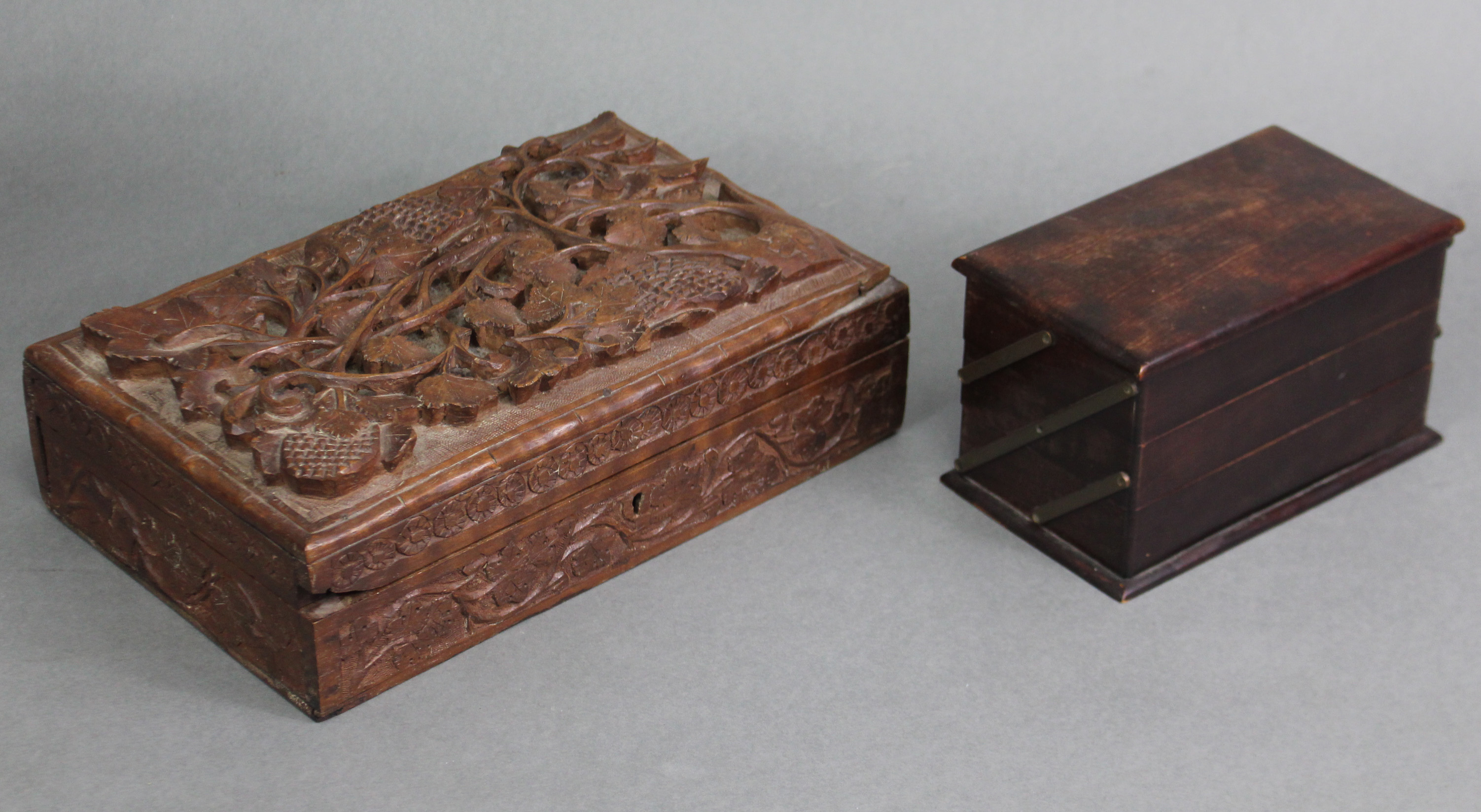 A Kashmiri carved teak rectangular box with all-over fruiting vine relief decoration, 11” wide x 3½”