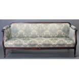 An early 19th century mahogany-frame sofa, with carved top-rail & apron, the padded back, seat, &