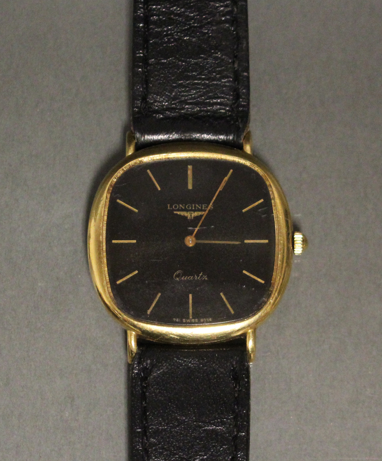 A Longines gent’s wristwatch in 18ct. gold case, the black square dial with rounded corners, gold