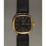 A Longines gent’s wristwatch in 18ct. gold case, the black square dial with rounded corners, gold