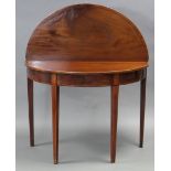 A George III inlaid-mahogany tea table with demi-lune fold-over top, the frieze drawer with