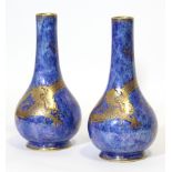 A pair of Wedgwood Dragon lustre pear-shaped vases, with gilt decoration of dragons chasing the
