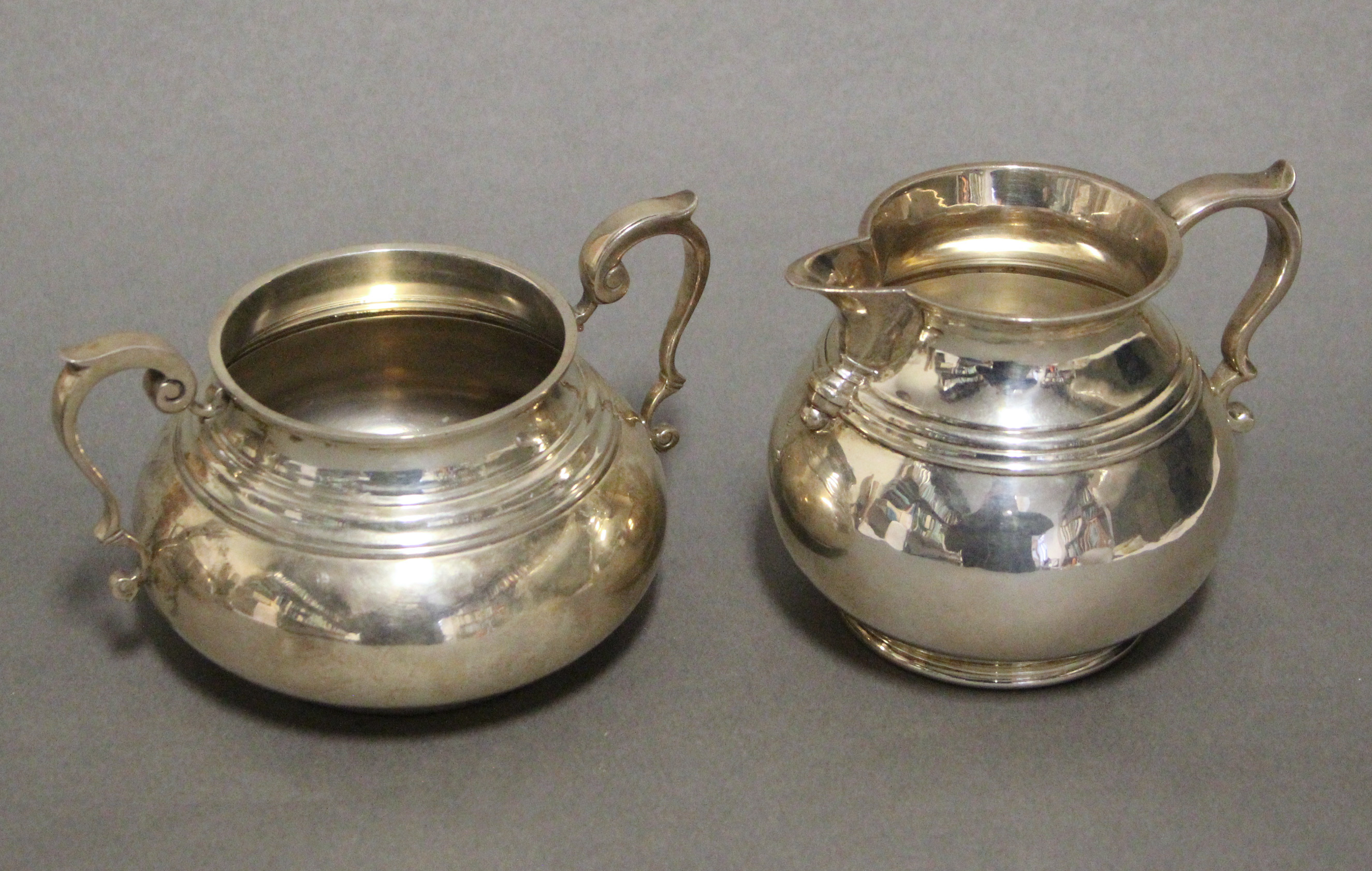 A George V heavy-gauge silver milk jug in the early 18th century style, of squat baluster form - Image 2 of 3