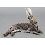 NICK MACKMAN; a contemporary ceramic sculpture titled: “Lying Down Hare”, glazed in naturalistic