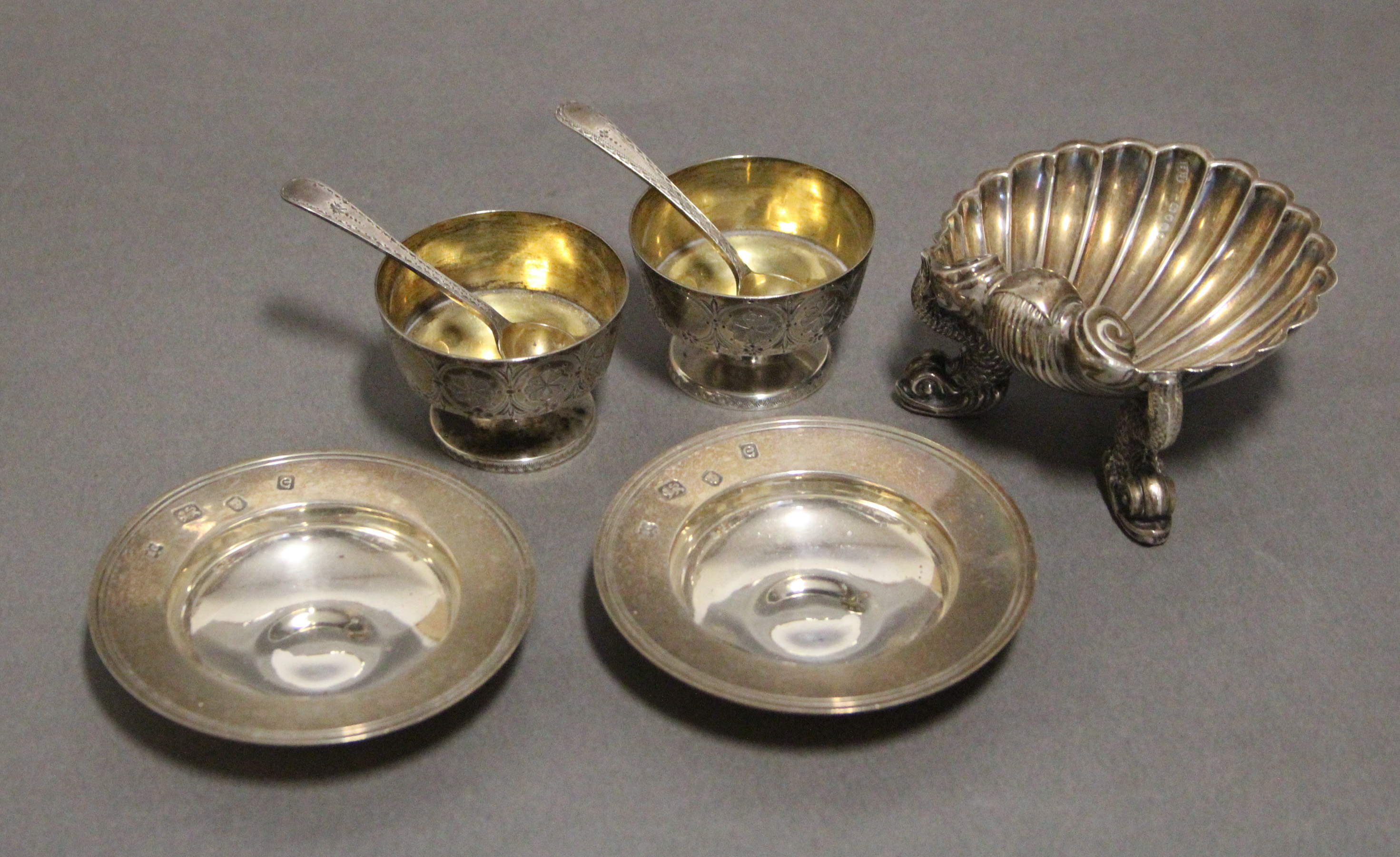 A Victorian silver scallop-shell dish on three dolphin supports, 3” wide, London 1867 by Henry