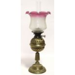 A Victorian brass oil table lamp of fluted design, with pink-tinted & etched glass shade; 20¾”