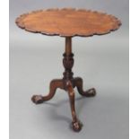 A 19th century Chippendale style mahogany tripod table with oval pie=crust top on vase-turned centre