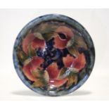 A Moorcroft “Pomegranate” circular shallow dish of mottled blue/green ground, painted initials &