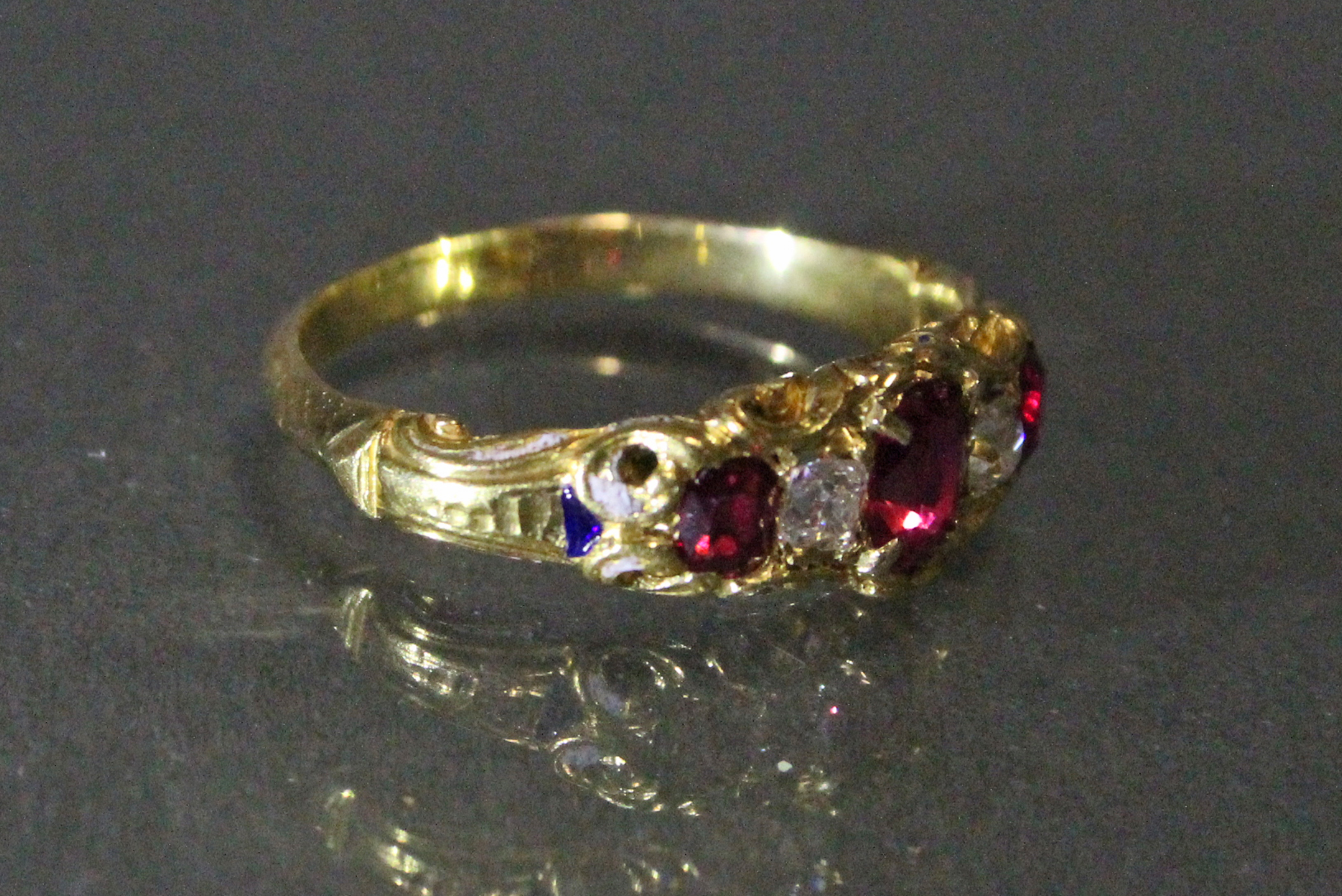 A Victorian un-marked gold ring set three oval rubies with cushion-shaped diamonds in between, - Image 2 of 3