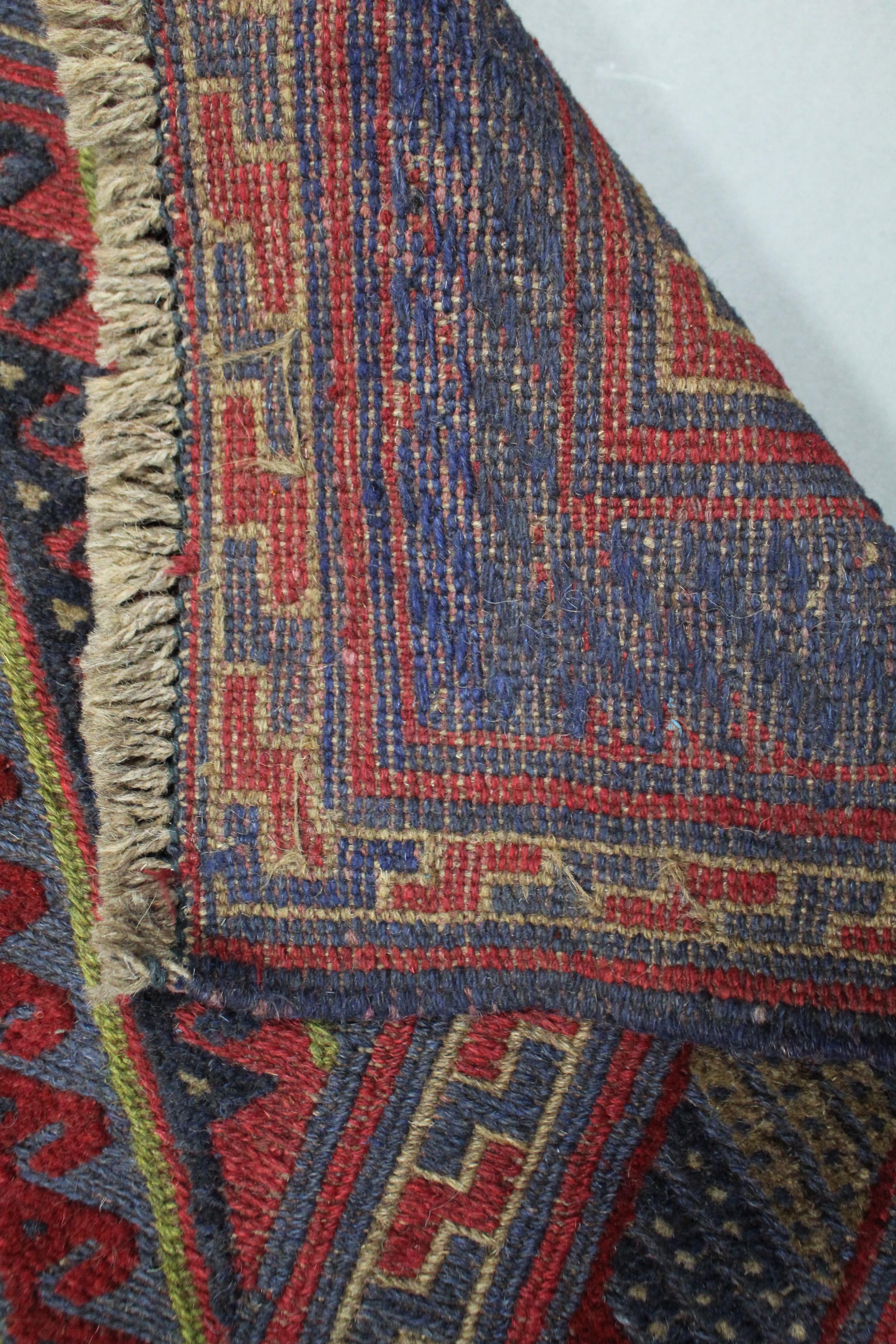 A Kazak rug of crimson, deep blue, & ivory ground with central hook & lozenge motif within - Image 2 of 2