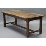 A late 19th/early 20th century Arts & Crafts oak dining table, with rectangular top fitted end draw