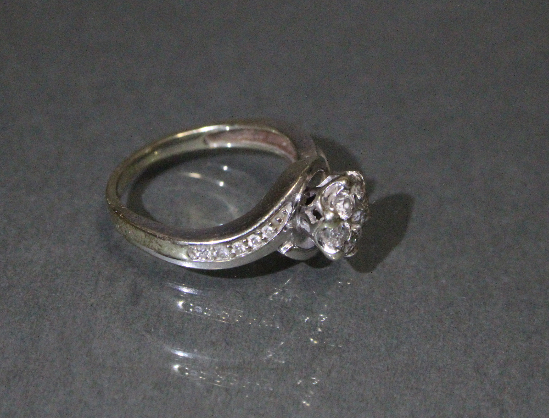 A diamond cluster ring set seven small stones, a row of five further stones to each curved shoulder, - Image 2 of 3