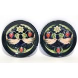 A pair of modern Moorcroft “Bird-&-Strawberry” small shallow dishes on a dark blue/green ground; 4½”