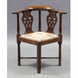 A mid-18th century mahogany corner elbow chair, with pierced & carved splats, flat curved open arms