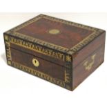 An early 19th century Goncalo Alves brass inlaid travelling toilet box, with fitted interior