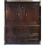 A LATE 17th/early 18th century OAK PRESS CUPBOARD, the upper part with moulded cornice, fitted two