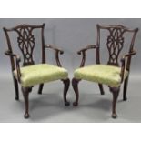A pair of 19th century Chippendale style carved mahogany armchairs with shaped & pierced splat