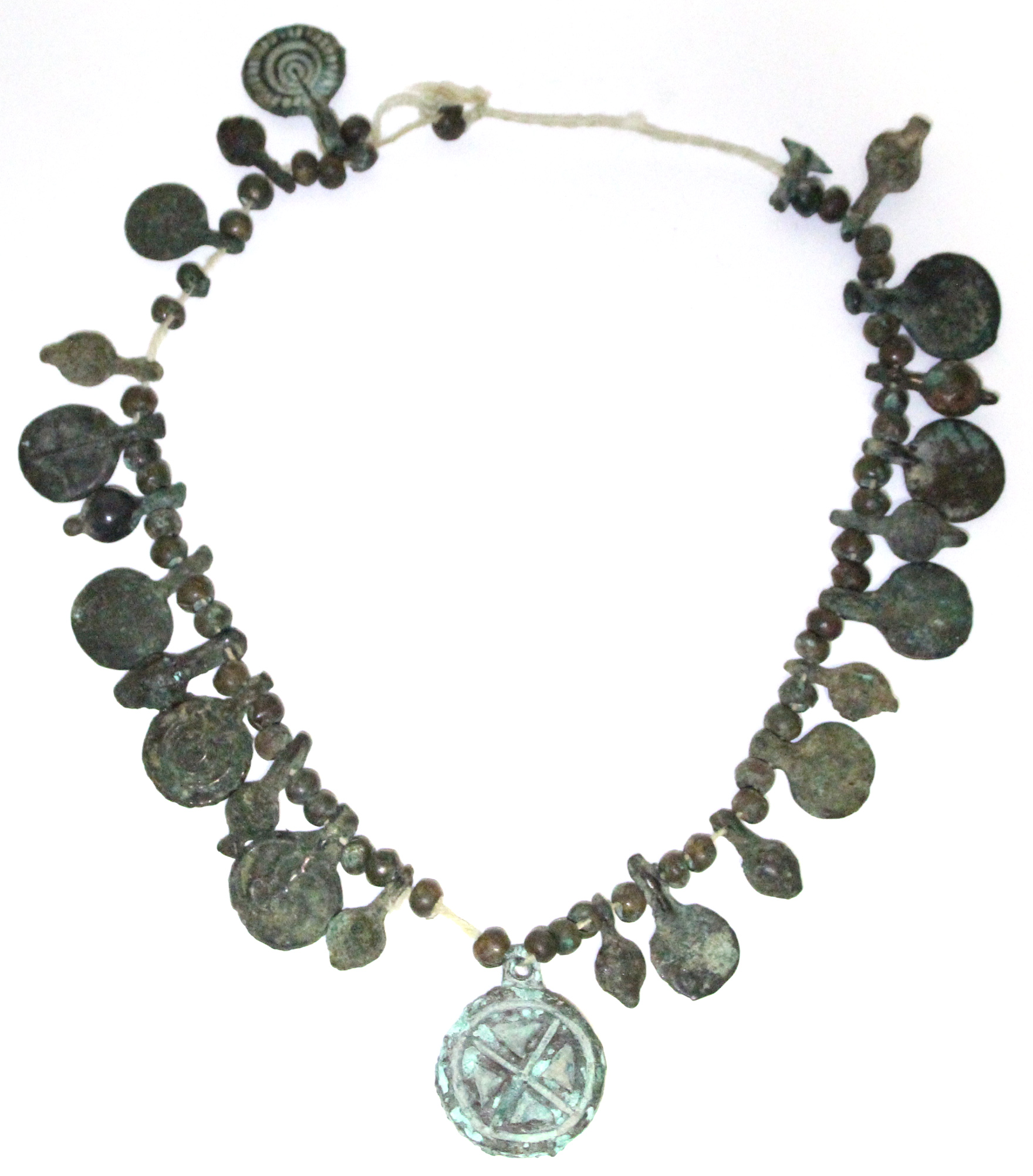 A Byzantine bronze necklace of decorated flat circular panels with small plain beads in between.