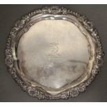 A George III silver waiter with cast gadroon & shell rim to the raised border, engraved family crest