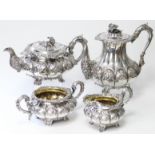 A WILLIAM IV SILVER FOUR-PIECE TEA & COFFEE SERVICE of melon shape, embossed with flower-heads