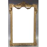 An 18th century style GILT-FRAME PIER GLASS, with husk-swag surmount, shaped corners, beaded inner