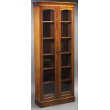 A late Victorian tall standing mahogany bookcase, fitted five adjustable shelves above two short
