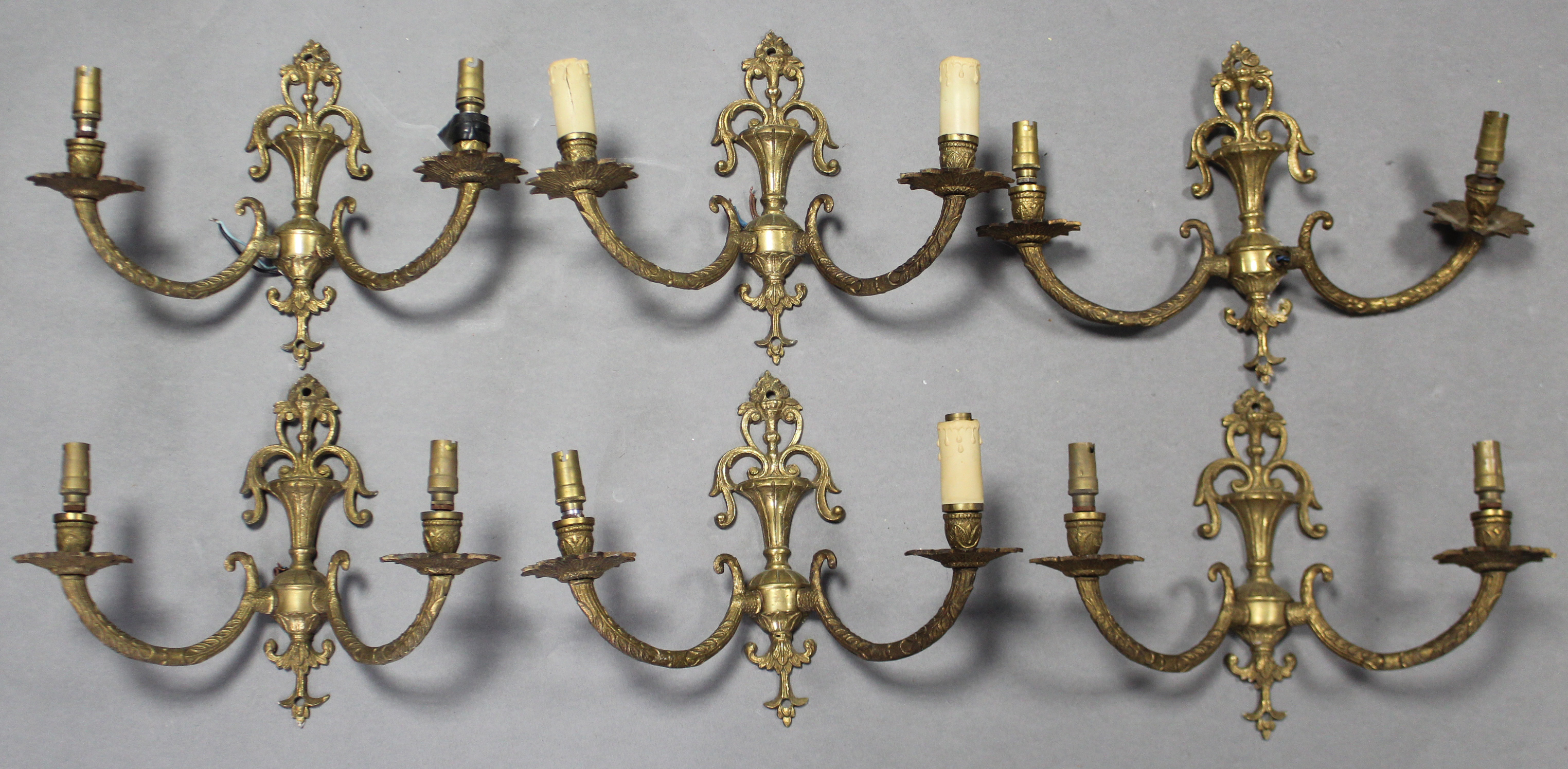 A set of six 20th century cast brass twin-branch wall lights of classical design, each 13” wide x