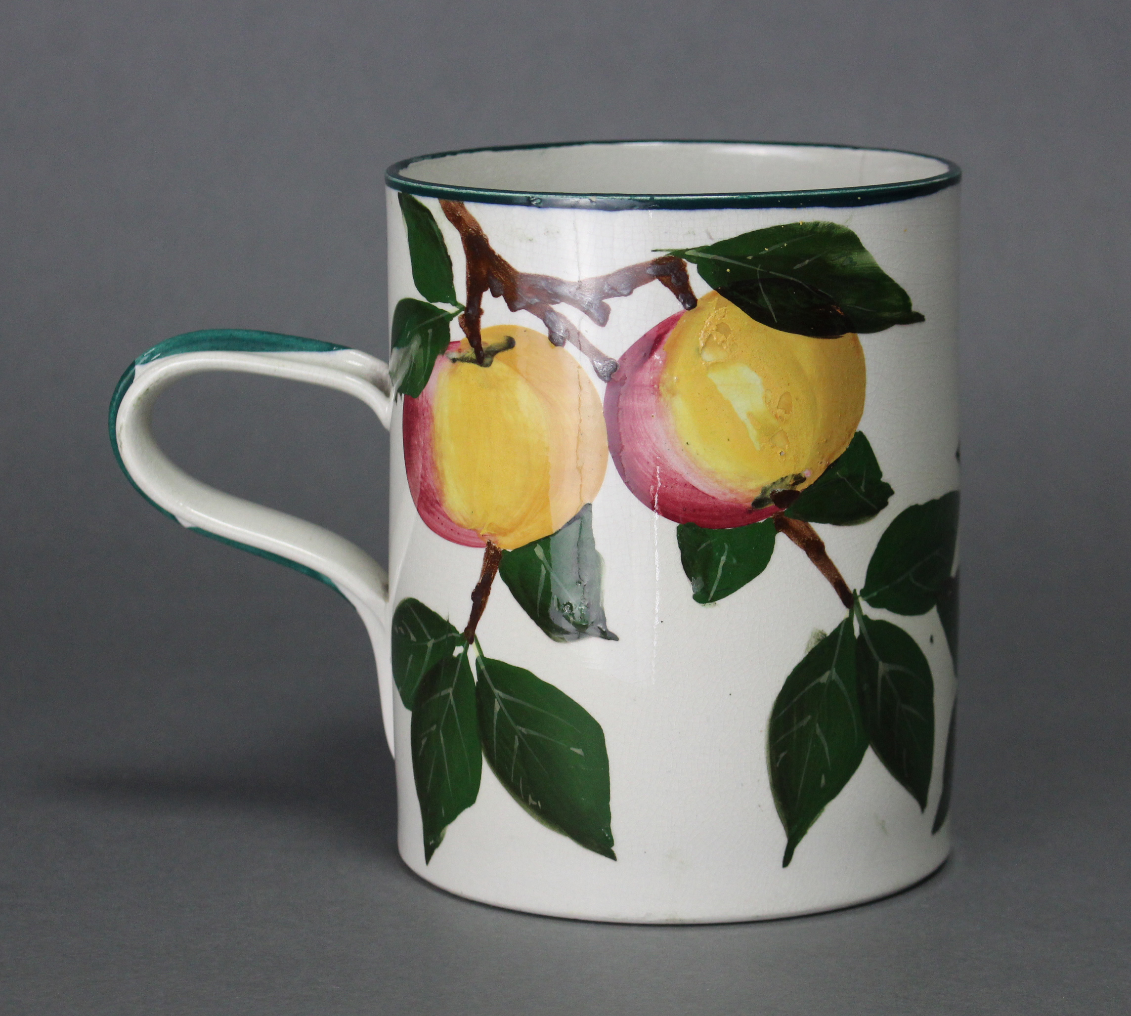 A Wemyss Ware (R. Heron & Son) pottery large cylindrical mug painted with the “Apples” pattern; - Image 2 of 4