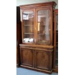 A mid-Victorian mahogany bookcase with moulded cornice, fitted three adjustable shelves enclosed