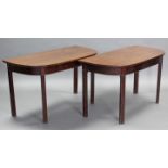 A pair of regency dining table end sections with rounded corners to the rectangular tops, each on