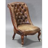 A Victorian carved mahogany frame buttoned-back nursing chair, with brown leather seta & back, on