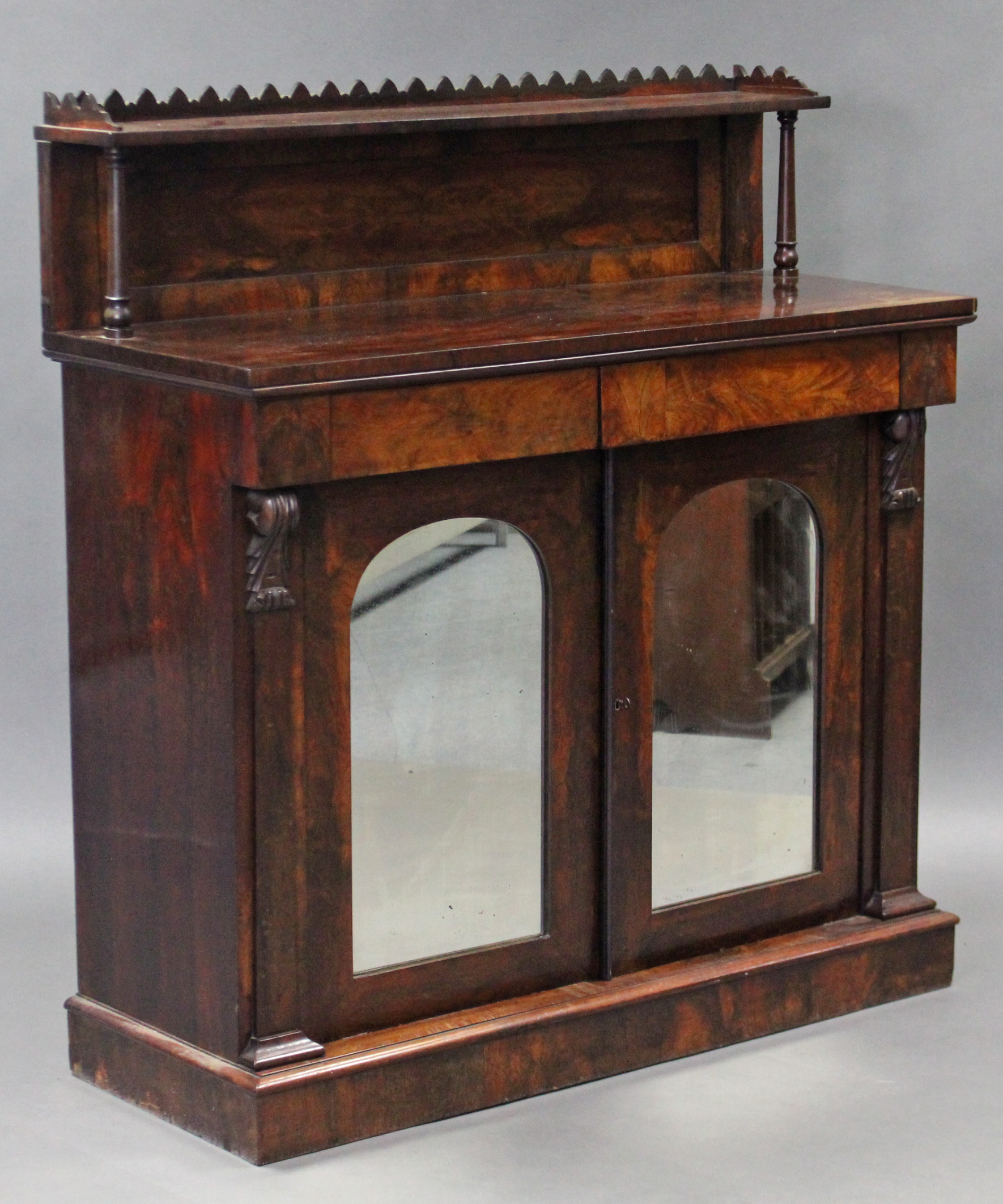 An early Victorian rosewood chiffonier, the stage top with carved gallery & turned supports,