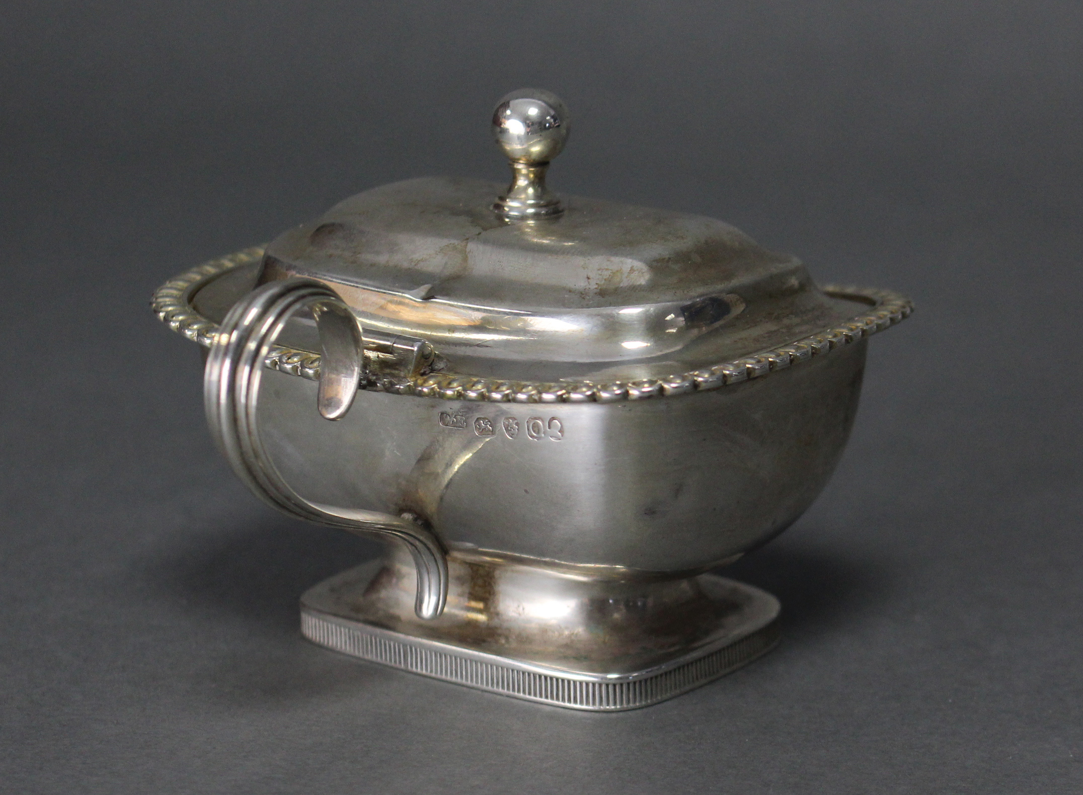 A George III silver mustard pot of compressed rectangular form, with gadrooned rim, ball finial to - Image 3 of 3