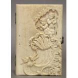 A TIFFANY & Co. IVORY RECTANGULAR NOTECASE, the front finely carved with cherub musicians,