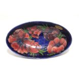 A Moorcroft “Anemone” shallow oval bowl of deep blue ground, painted initials & impressed marks;