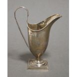 A Victorian silver helmet-shaped cream jug in the late 18th century style, with loop handle & on