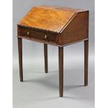 A late George III mahogany clerk’s desk with fitted interior enclosed by a fall front & on square