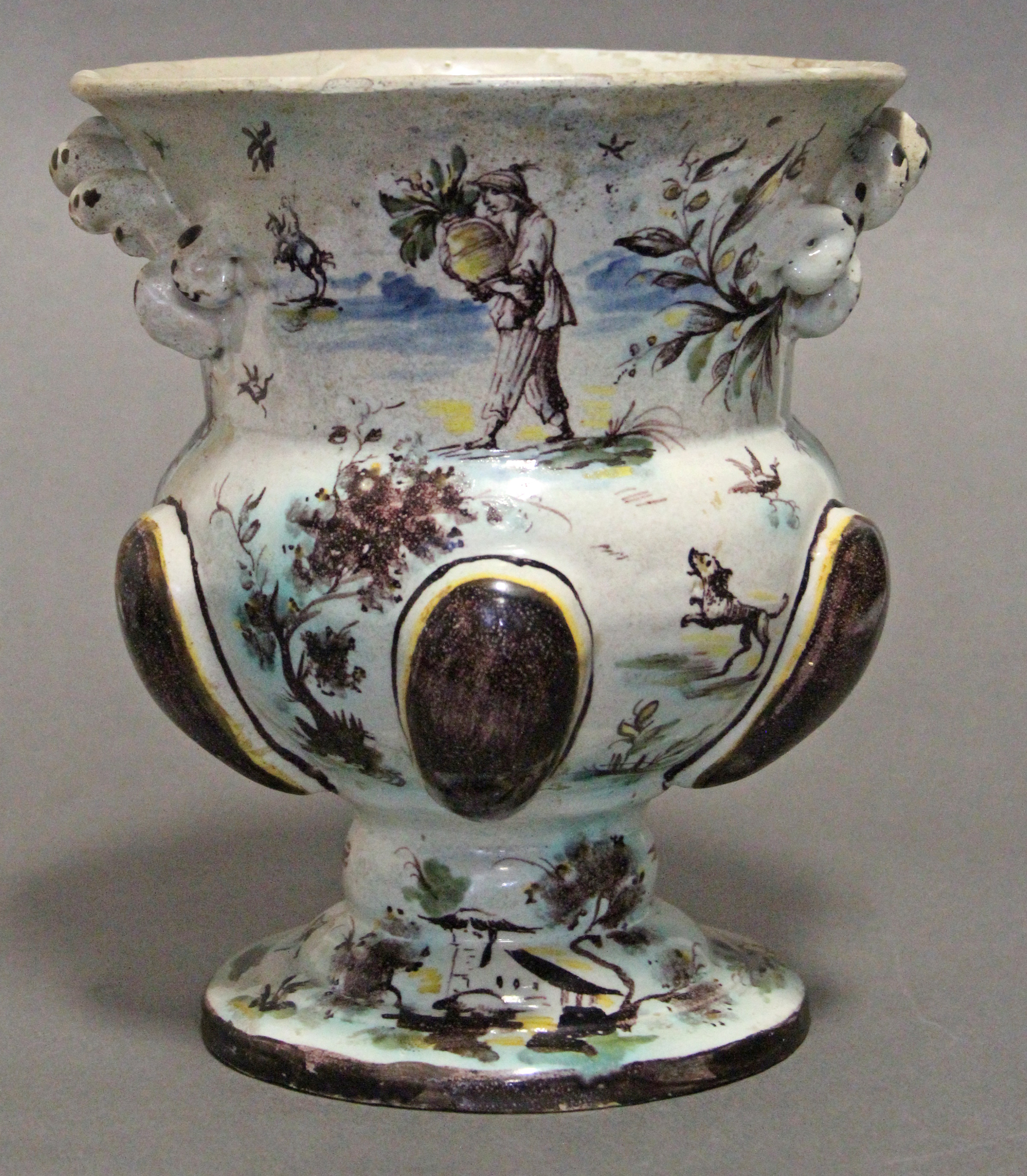 A 17th/18th century continental faience urn-shaped vase with polychrome decoration of figure scenes,