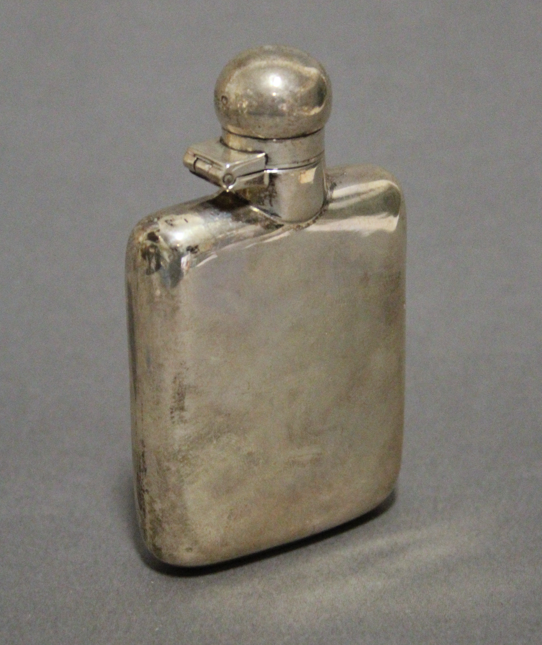 A George V silver plain rectangular pocket spirit flask with hinged ball cap, 3¾” high; Sheffield