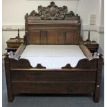 A 17th century-style OAK DOUBLE BEDSTEAD, incorporating early elements, with shaped side rails &