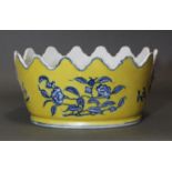 A Chinese porcelain oval jardinière of monteith shape, with underglaze blue decoration on a yellow