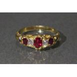 A Victorian un-marked gold ring set three oval rubies with cushion-shaped diamonds in between,