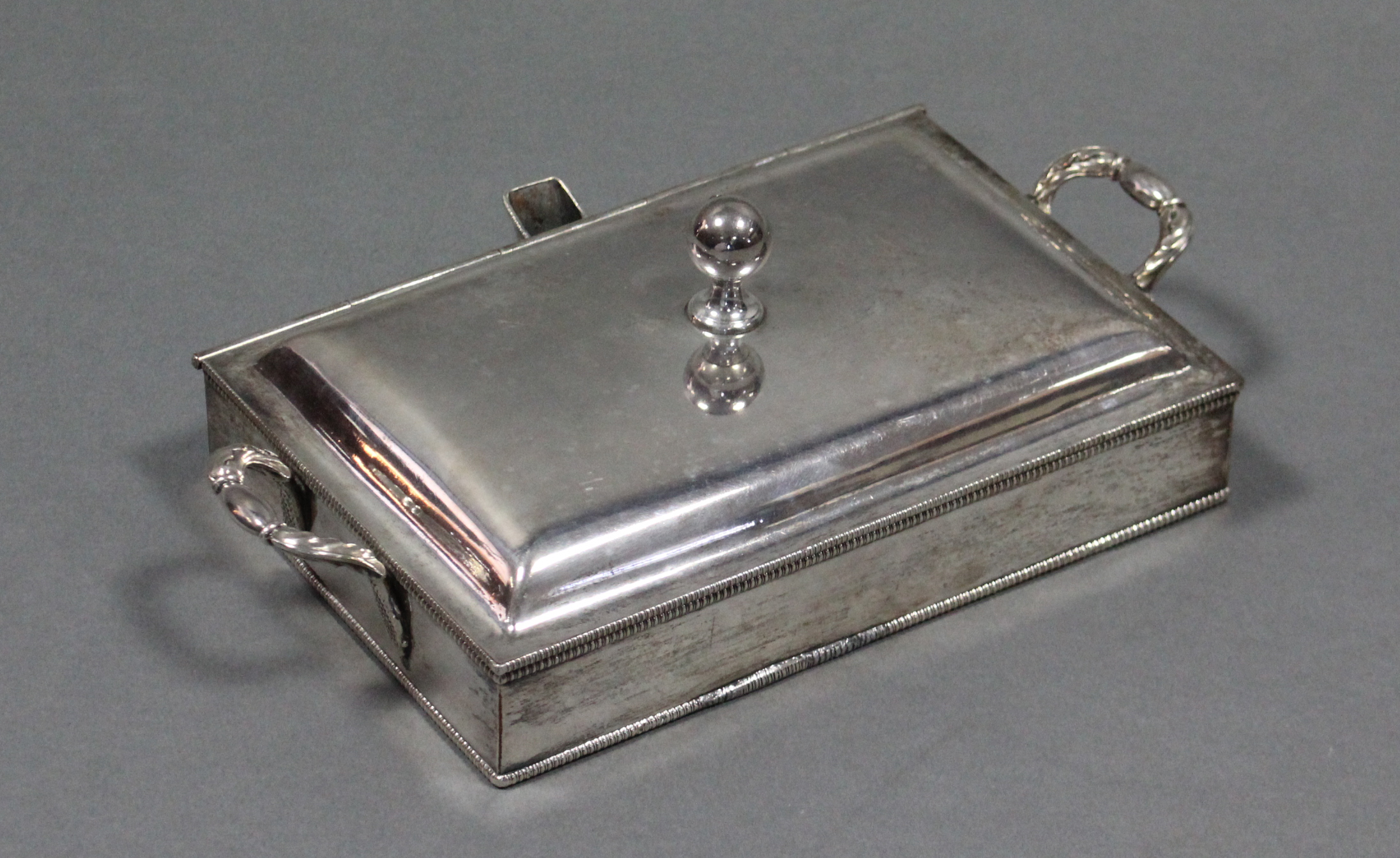 An Old Sheffield plated rectangular hotwell serving dish with hinged lid, gadrooned rims, &
