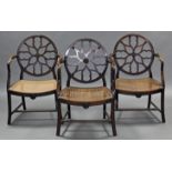 A set of three late 19th century Hepplewhite style elbow chairs with carved & pierced wheel backs,