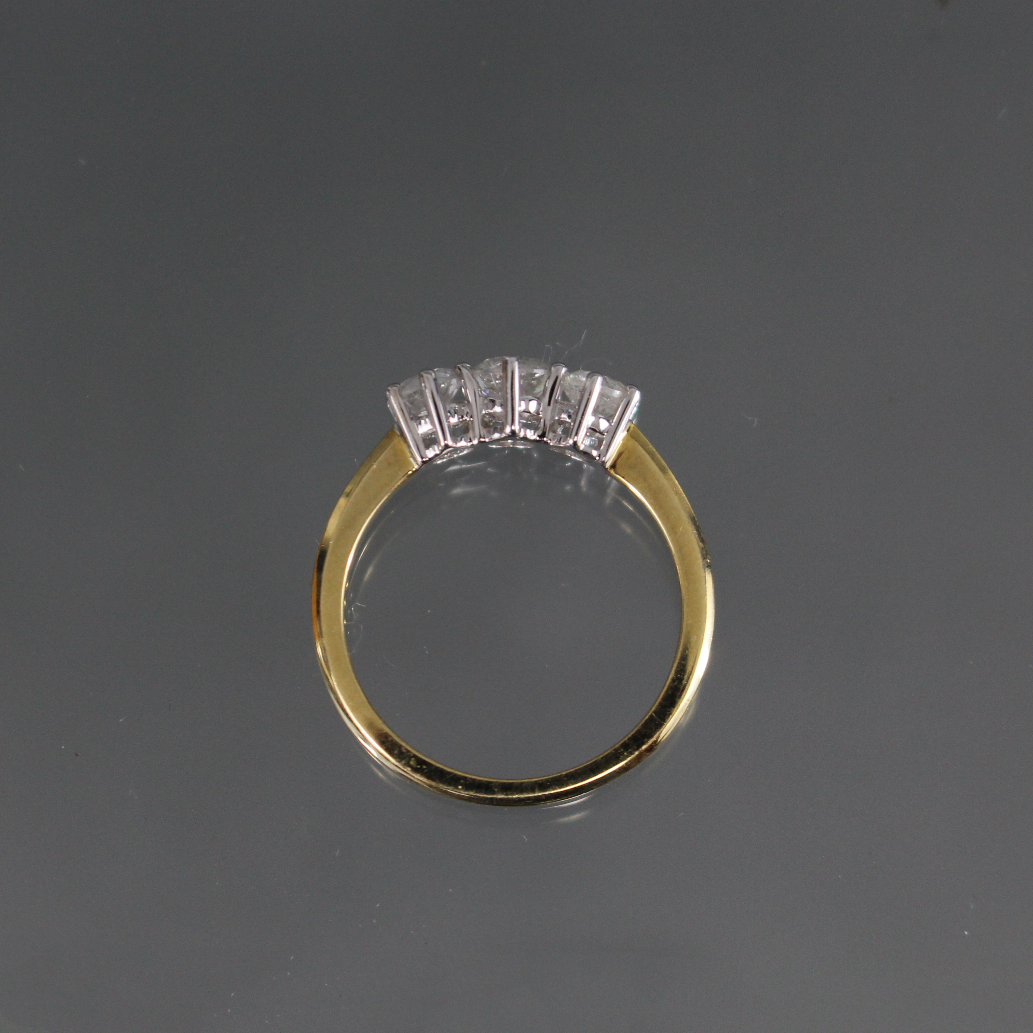 An 18ct. gold ring set three graduated diamonds, the centre stone approx. 0.5 carat, the two smaller - Image 2 of 2