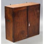 AN EARLY 19th century TEAK CAMPAIGN WALL-MOUNTED CABINET, fitted with an arrangement of five shelves